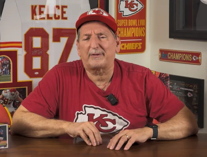 Arrowhead Paesano at his studio desk in a Chiefs shirt